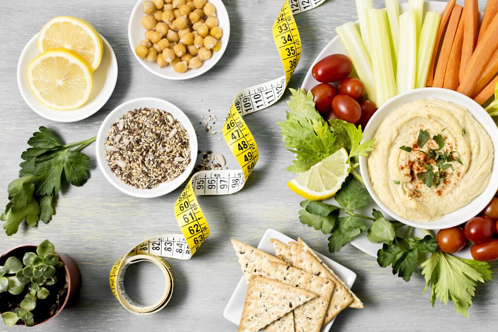 top-view-hummus-with-assortment-vegetables-measuring-tape